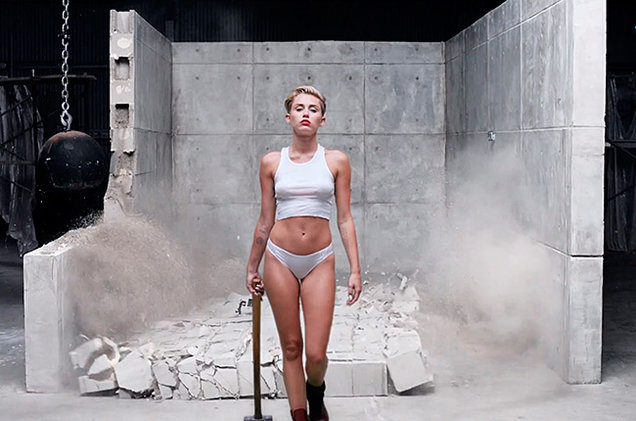 Miley Cyrus cries, swings around naked in Wrecking Ball 