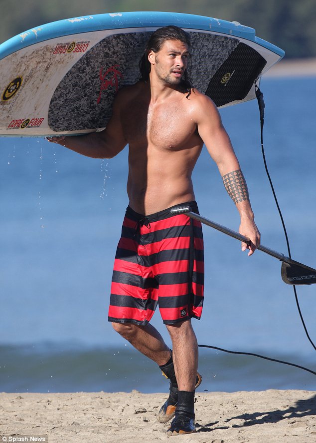 Jason Momoa shirtless with surf board
